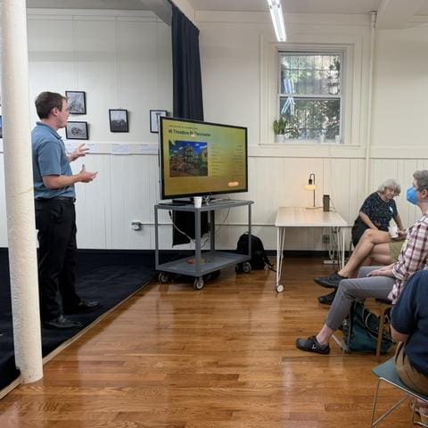 Aidan presenting a property slide to a seated group