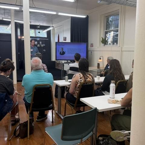 Attendees seated at tables during a HomeMates co-buying session